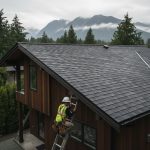 Modern Vancouver home featuring new asphalt shingle roof under rainy BC sky with inspecting roofer